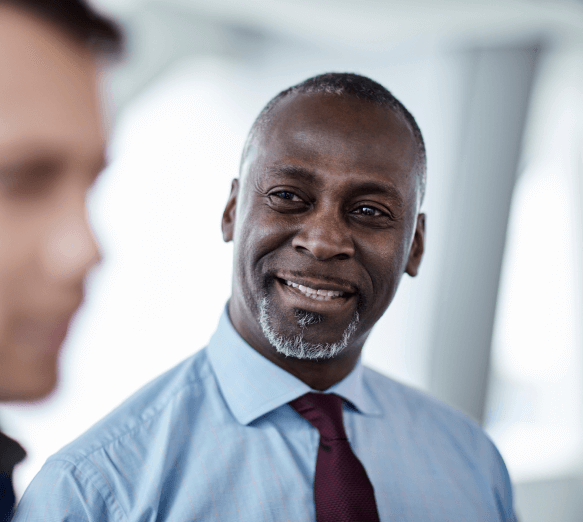 close up of a male smiling at another male